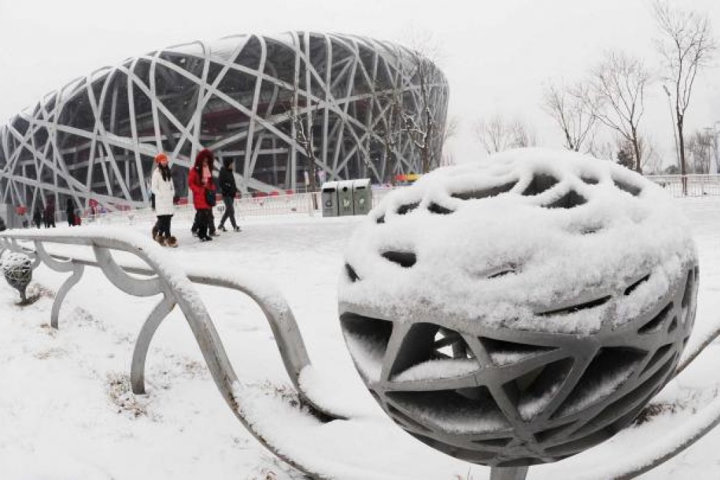 A snow-covered Beijing Olympic Park yesterday. More than a hundred flights in the capital were cancelled or delayed. Photo: Xinhua