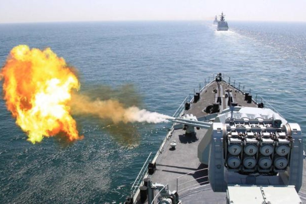 A Chinese missile destroyer fires during Russia-China joint naval exercises in the Yellow Sea. Photo: Xinhua
