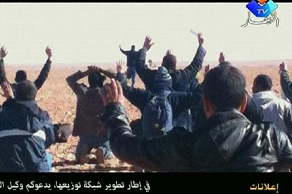 Hostages are seen with their hands in the air at the In Amenas gas facility in this still image taken from video footage taken last week. Photo: Reuters