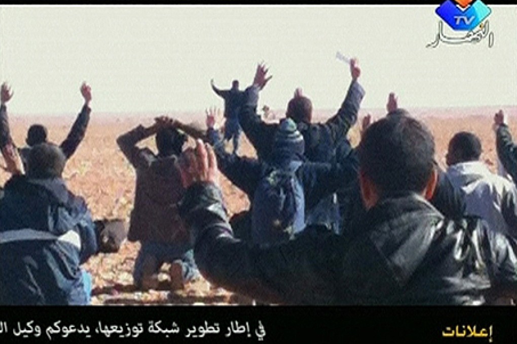Hostages put their hands in the air at the In Amenas gas facility in this still image taken from video footage taken last week. Photo: Reuters
