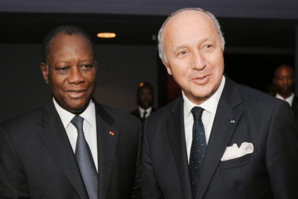 French Foreign Minister Laurent Fabius (right) is welcome by Ivory Coast's President and ECOWAS chairman Alassane Ouattara in Abidjan. Photo: AFP