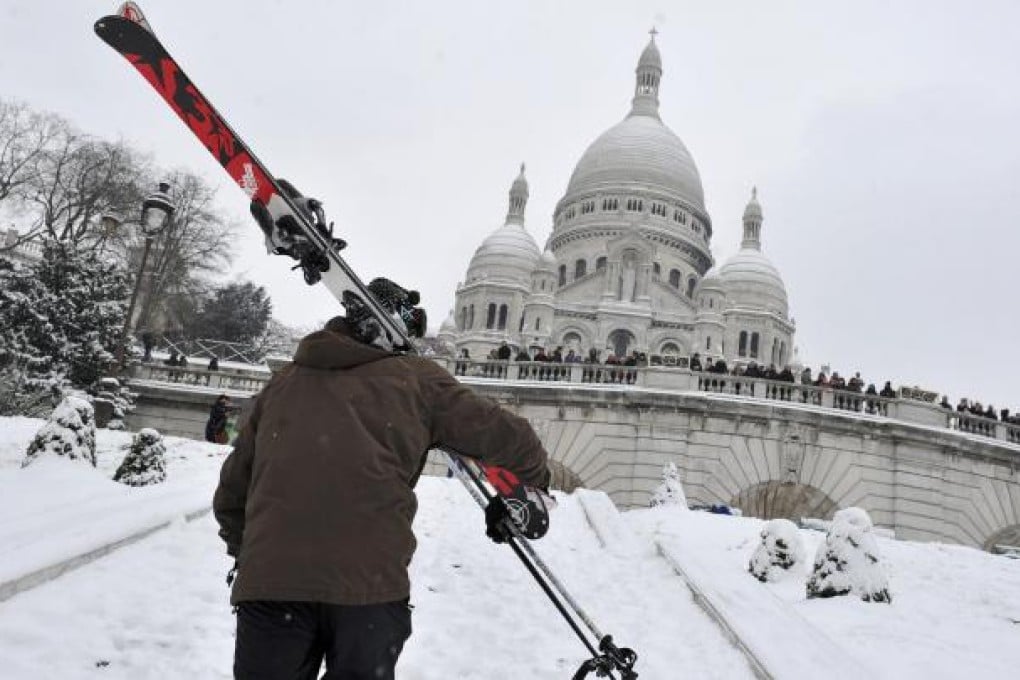 Skiers on snow-covered Montmartre near the Sacré Coeur Basilica enjoyed some of the most efficient transport in Paris yesterday. Photo: AP