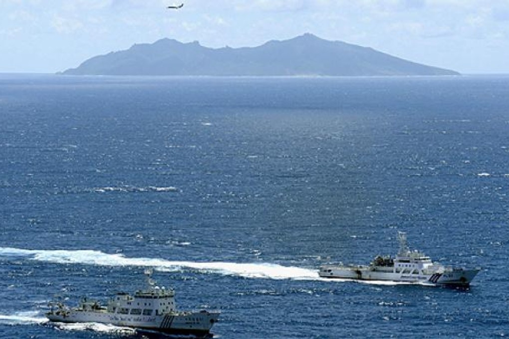 A Chinese marine surveillance ship and a Japanese coastguard ship cruise near one of the disputed islands in September. Photo: Reuters