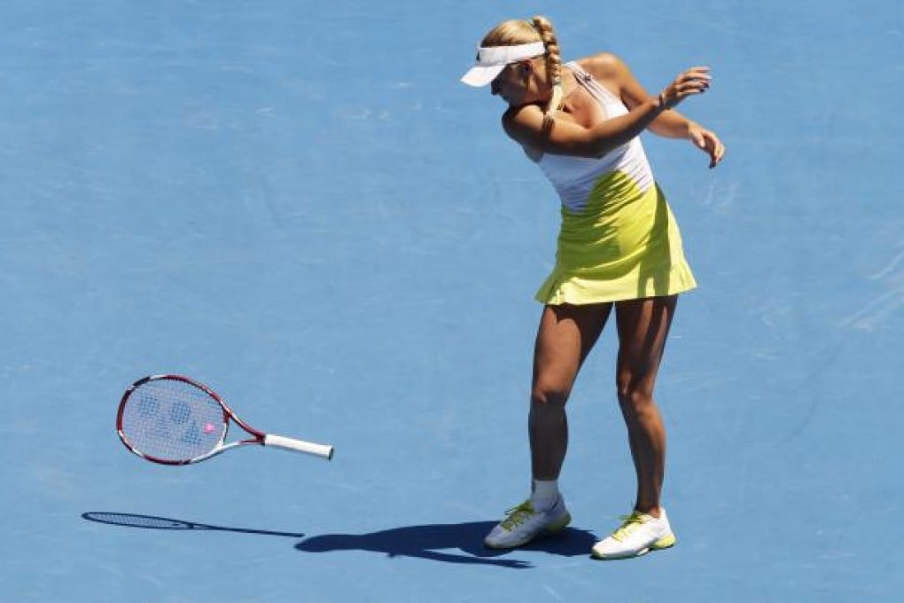 Caroline Wozniacki throws her racket on Monday during the match. Photo: EPA