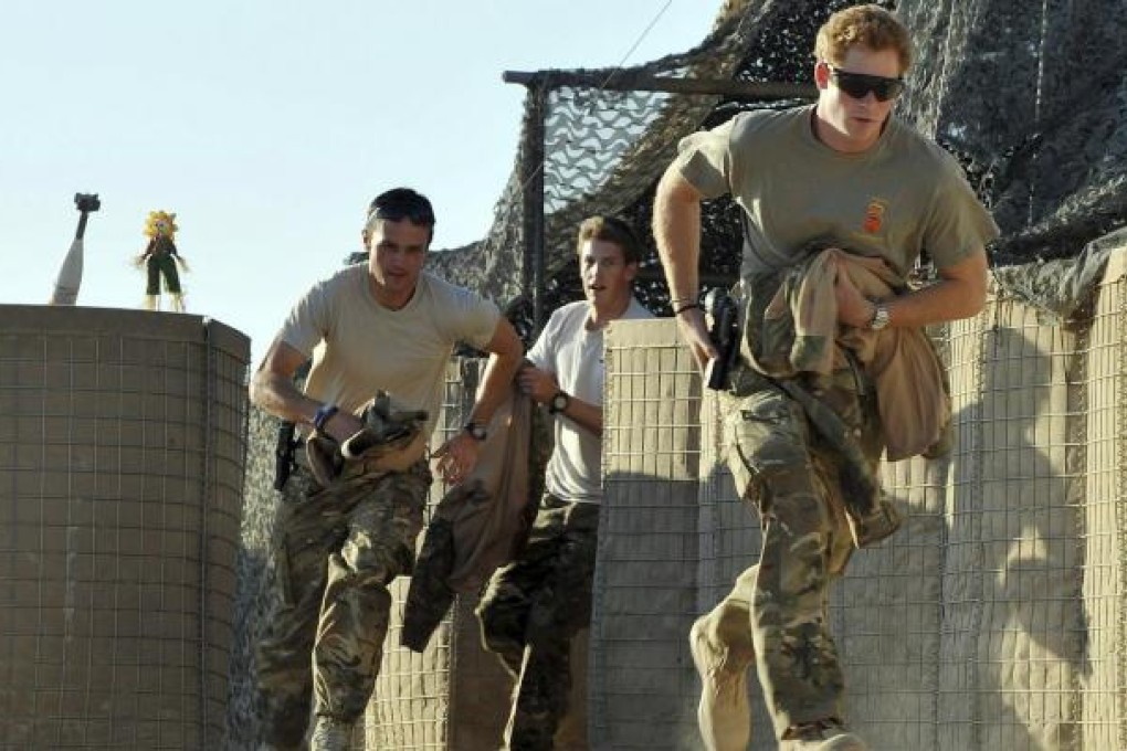 Prince Harry leads his crew in a scramble to their helicopter at Camp Bastion in southern Afghanistan on November 3. Photo: Reuters