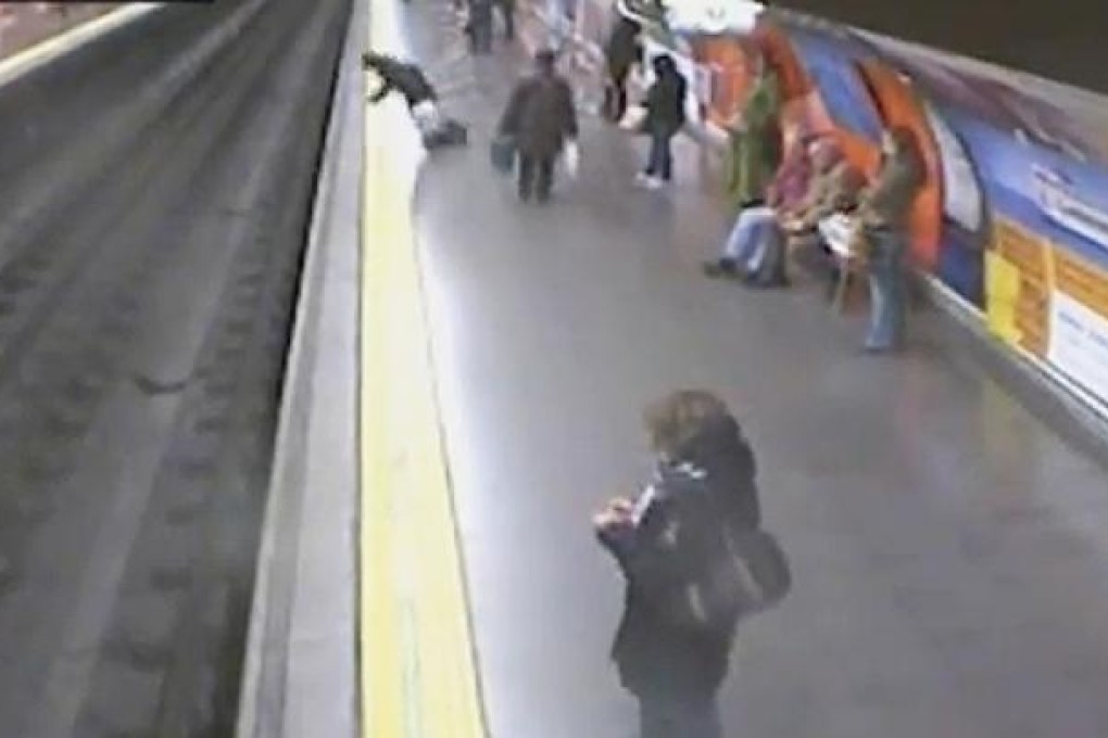 A screengrab shows the woman fall onto the tracks of the Madrid subway system moments before a train arrived.