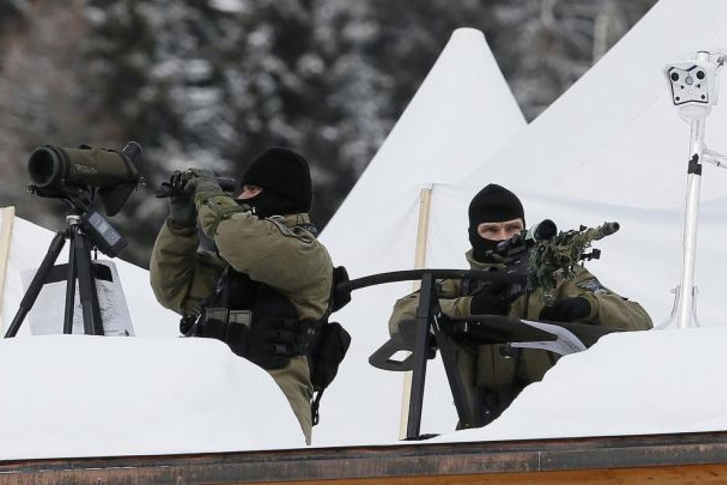 Members of Swiss special police forces stand on the roof of the Congress Hall of the World Economic Forum in Davos. Photo: Reuters
