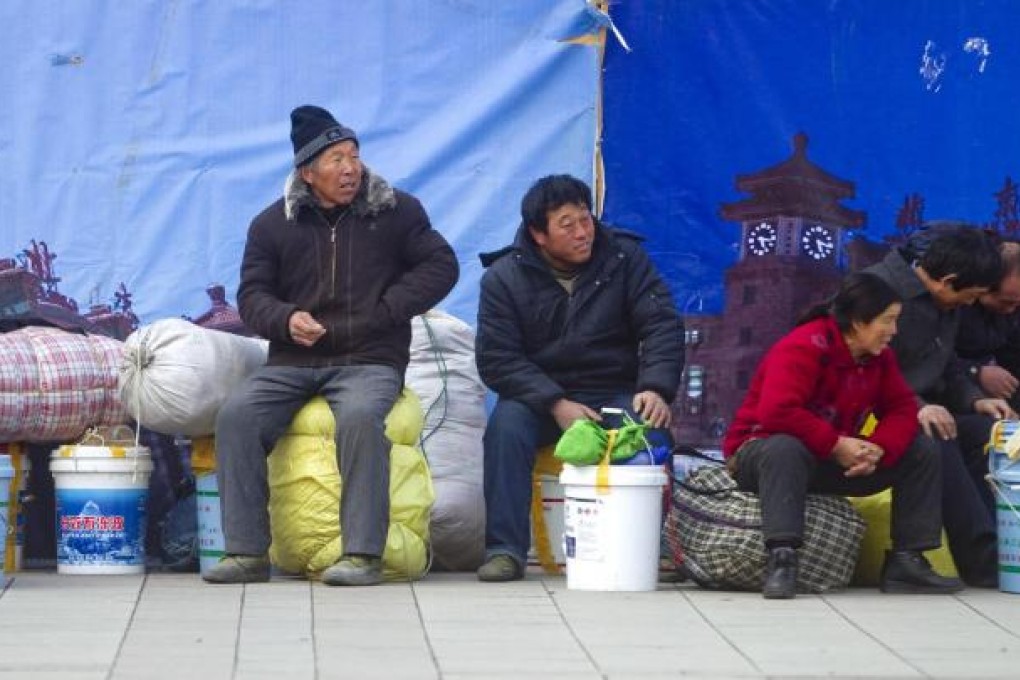 Migrant workers wait at a Beijing station, hoping to leave early and avoid the crowds when the Lunar New Year peak travel period begins on Saturday. Photo: EPA