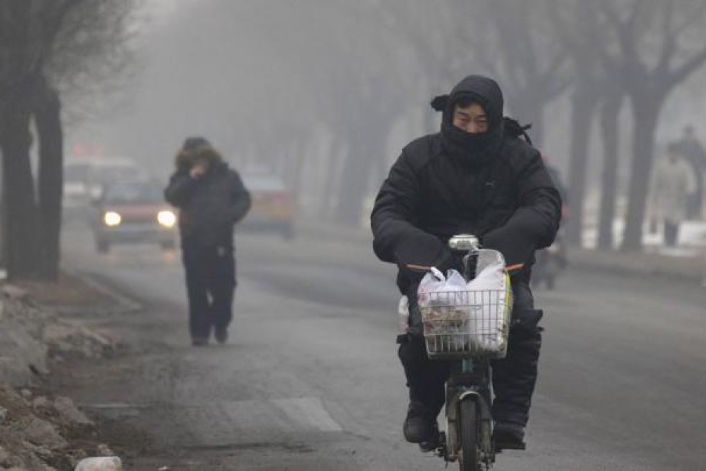 Beijing was shrouded in smog again yesterday. The city plans to remove 180,000 old vehicles from its roads this year. Photo: Reuters