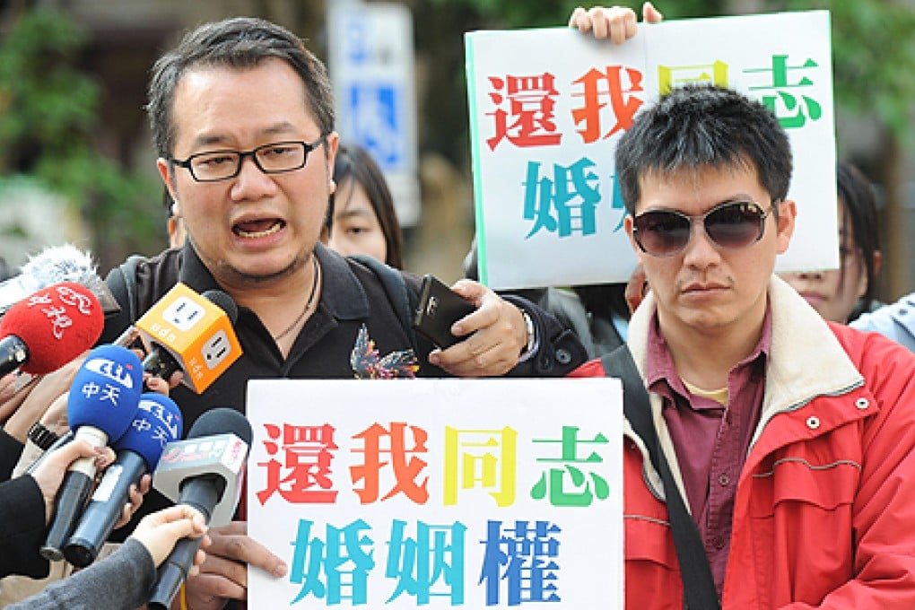 Chen Ching-hsueh (left) and his partner Kao Chih-wei call for same-sex marriage rights outside a court in Taipei in January. Photo: AFP