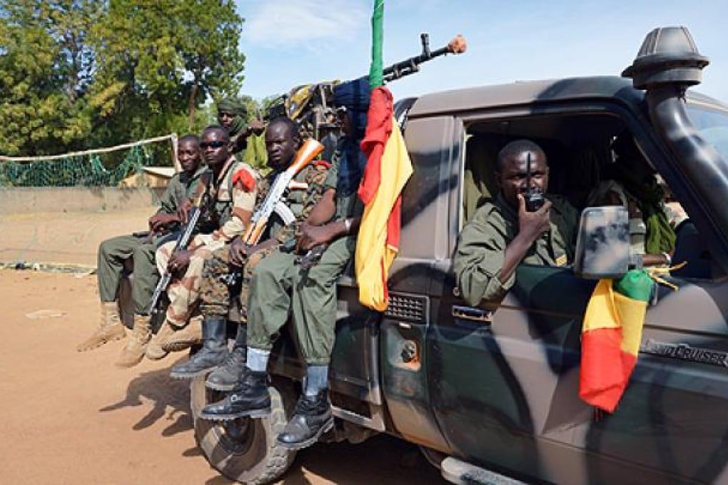 Malian soldiers patrol in Diabaly on Wednesday after French and Malian troops recaptured the frontline towns of Diabaly and Douentza in a major boost to their push north to flush out al-Qaeda-linked rebels. Photo: AFP