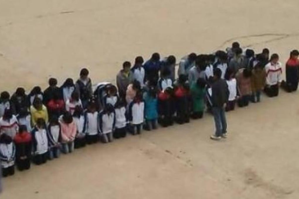 Middle school students kneel in a playground. Picture: Screenshot from Weibo.