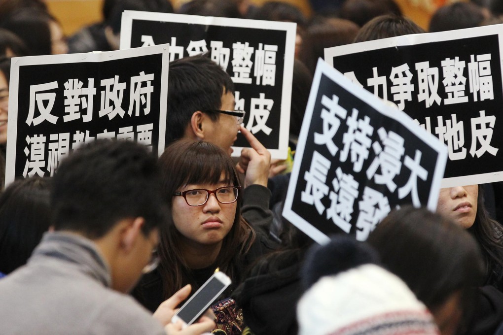 Students rally in North Point yesterday after a night spent petitioning at the government's Tamar offices. Photo: Edward Wong
