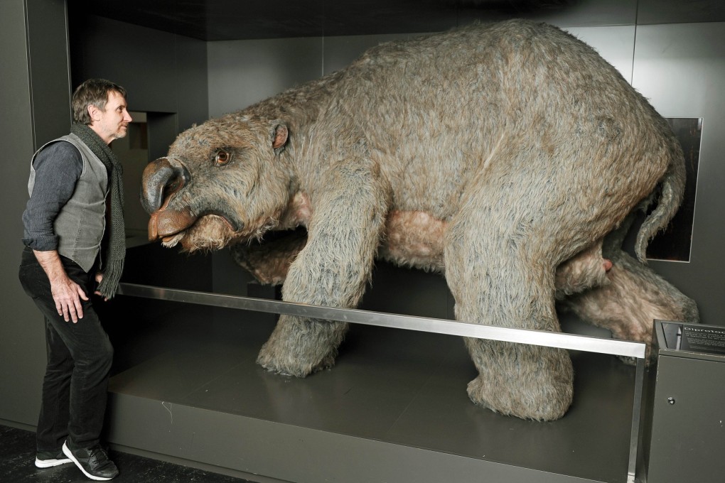 Brendan Atkins, publications co-ordinator and editor at the Sydney Museum, stands next to a model of the rhino-sized mega wombat Diprotodon. Photo: AFP