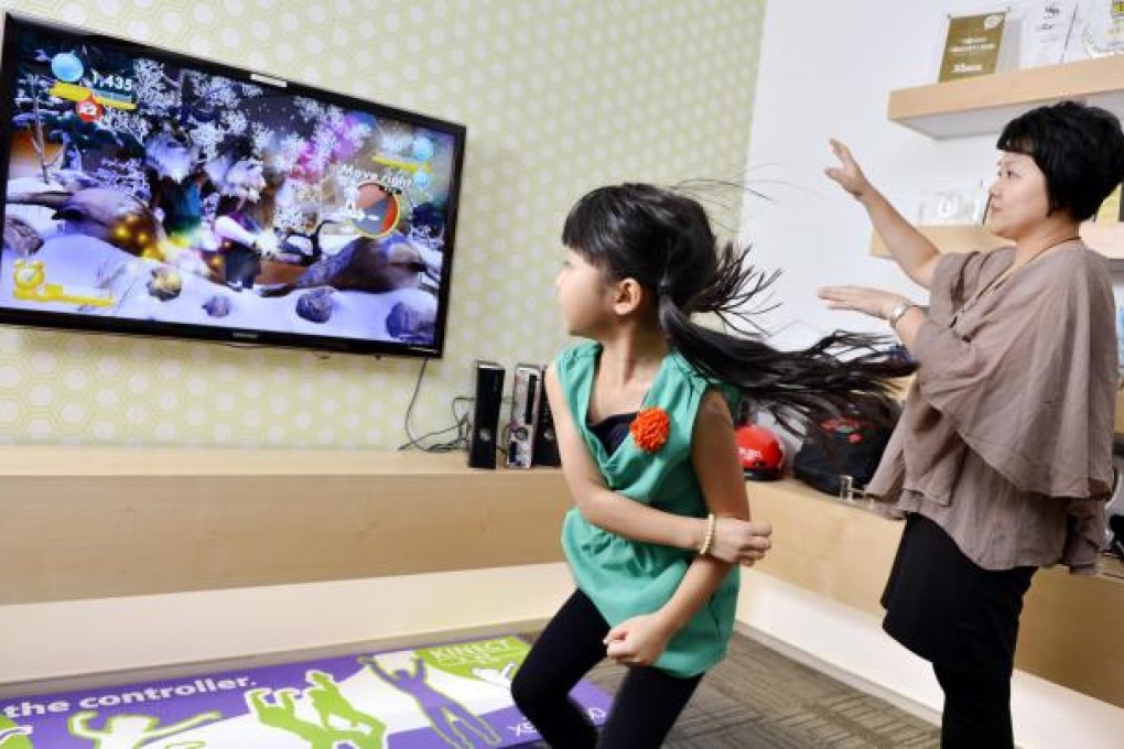 Vanessa Yau tries out a new game with her mother, Kenix Chong. Photos: Warton Li