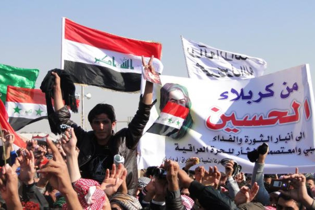 Iraqi-Sunni protestors and Shiite demonstrators from the Karbala provinces and the Baghdad Shiite suburb of Sadr City wave banners during a demonstration. Photo: AFP