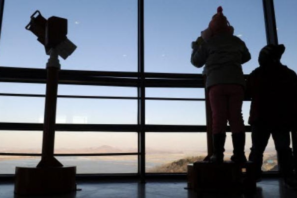 Visitors look toward North Korea's border county of Kaepoong from a South Korean observation post. Photo: AFP