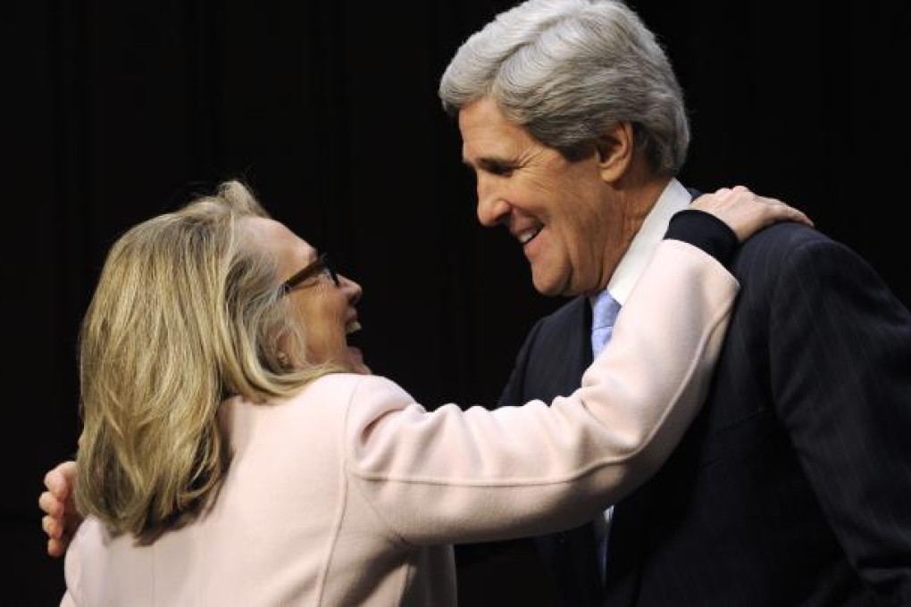 Hillary Clinton hugs Senator John Kerry. Photo: Xinhua