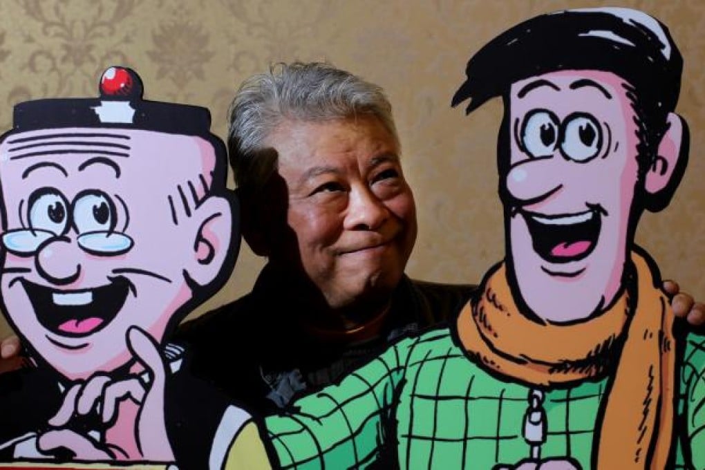 Joseph Wong, who draws and writes the comic book his father created in the 1960s, with some familiar faces at a 50th anniversary exhibition. Photo: Nora Tam