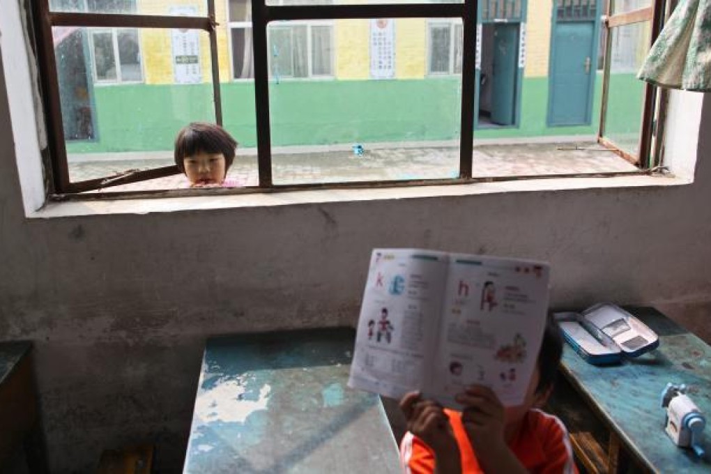 School for migrant children starts school term early as forced closure looms. Migrant workers in cities are generally poorly educated mainly due to a hereditary household registration. Photo: EPA