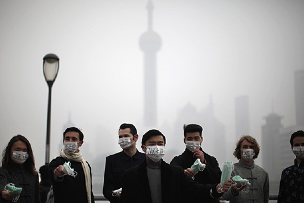 Green activists hand out masks to pedestrians on The Bund in Shanghai last week. Photo: Reuters