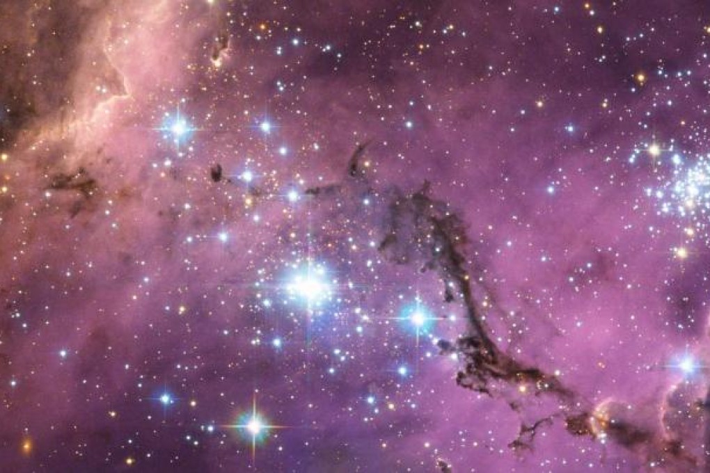 A photo taken by the European Space Agency shows nearly 200 000 light-years from Earth, the Large Magellanic Cloud, a satellite galaxy of the Milky Way, floats in space. Photo: AFP