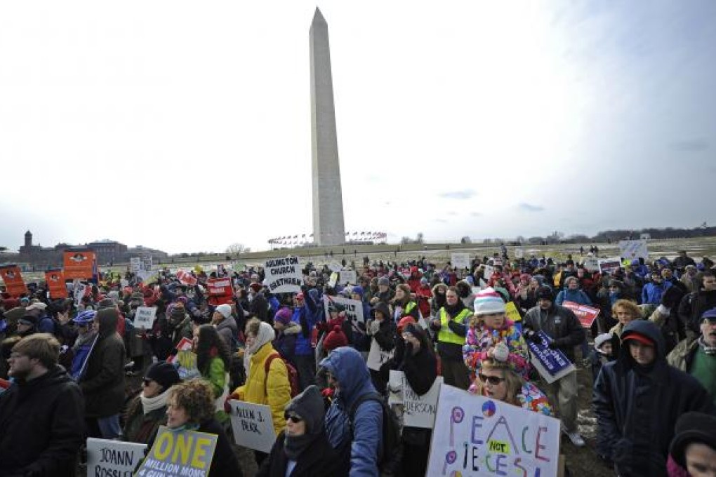 Protesters hold up placards during the March on Washington for Gun Control on Saturday. Photo: Xinhua