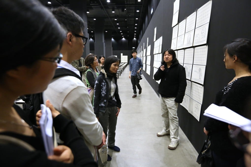 Conceptual artist Song Dong (centre) discusses his 36 Calendars exhibition with Post readers at ArtisTree.