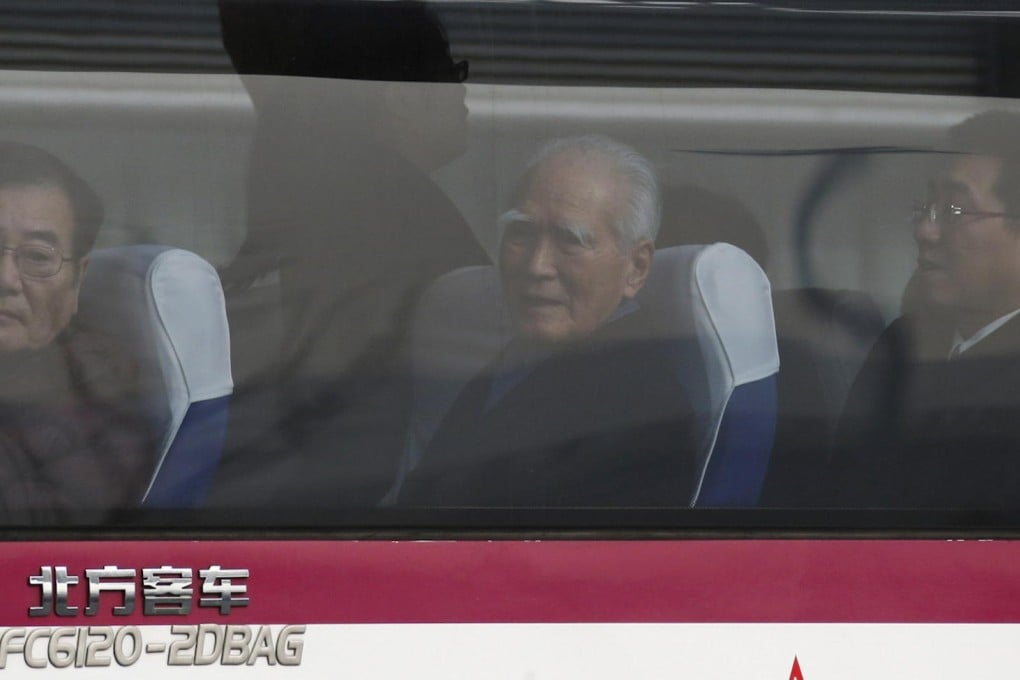 Former Japan prime minister Tomiichi Murayama (centre) and delegates look out of a bus after landing in Beijing yesterday. Photo: Reuters