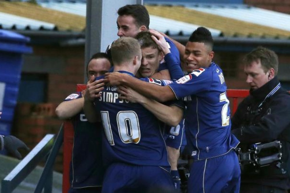 Oldham celebrate a Matt Smith goal. Photo: Reuters