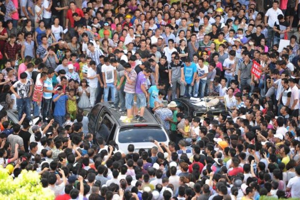 Protesters outside Qidong government offices.Photo: AFP