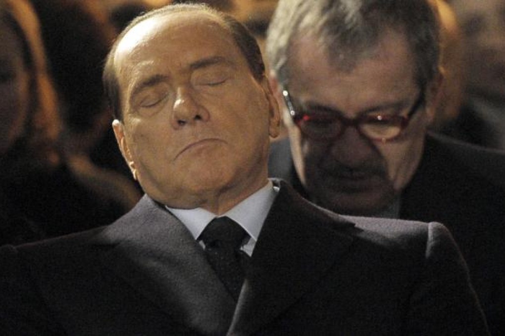 Silvio Berlusconi appears to be asleep at a Holocaust commemoration on Sunday in Milan. Photo: AP