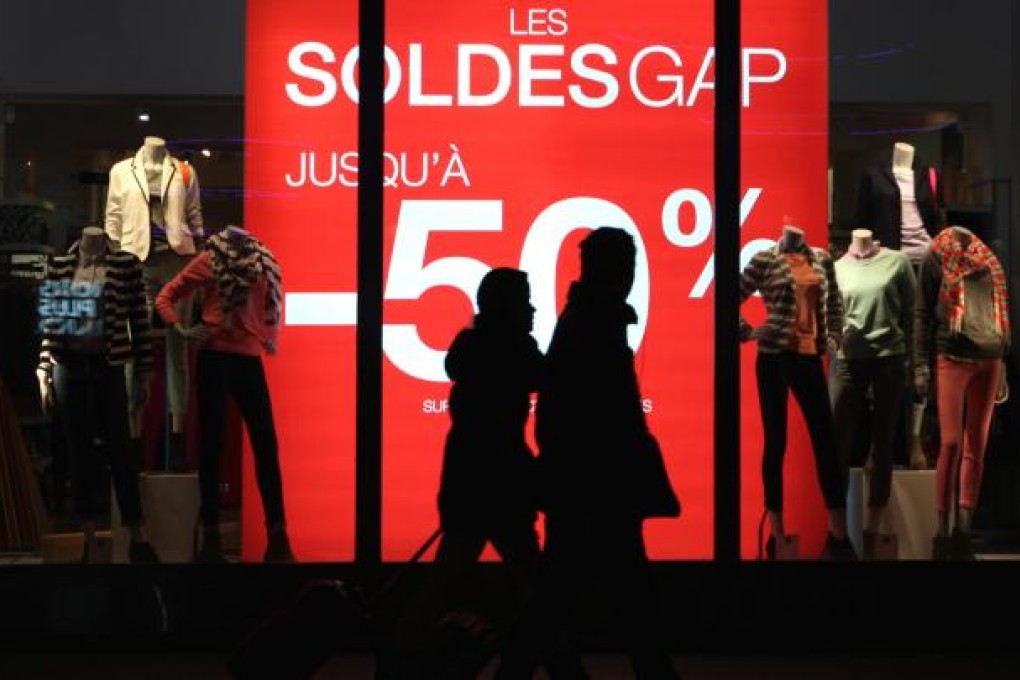 A shop in Champs-Elysees Avenue is lit up. Photo: Xinhua