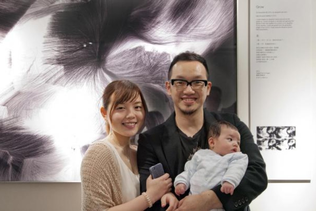 Henry Chu and his family in front of his hair-raising work Grow.