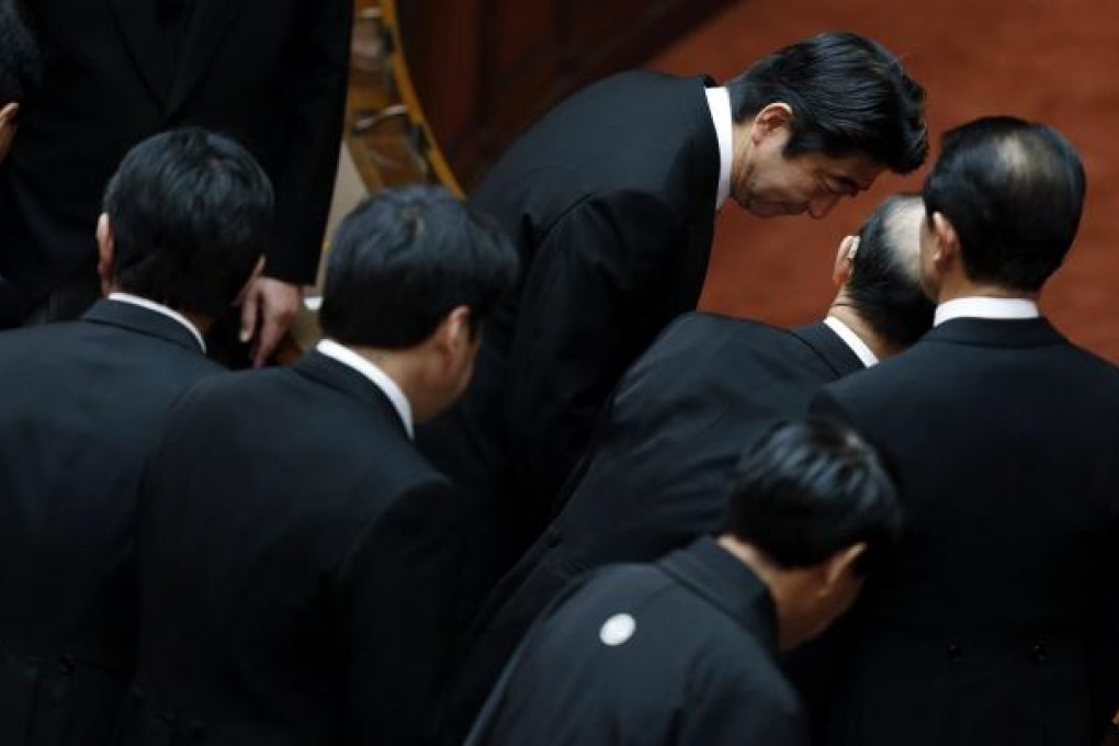 Japan’s Prime Minister Shinzo Abe (top centre) bows to other lawmakers at the opening of parliament in Tokyo. Photo: Reuters