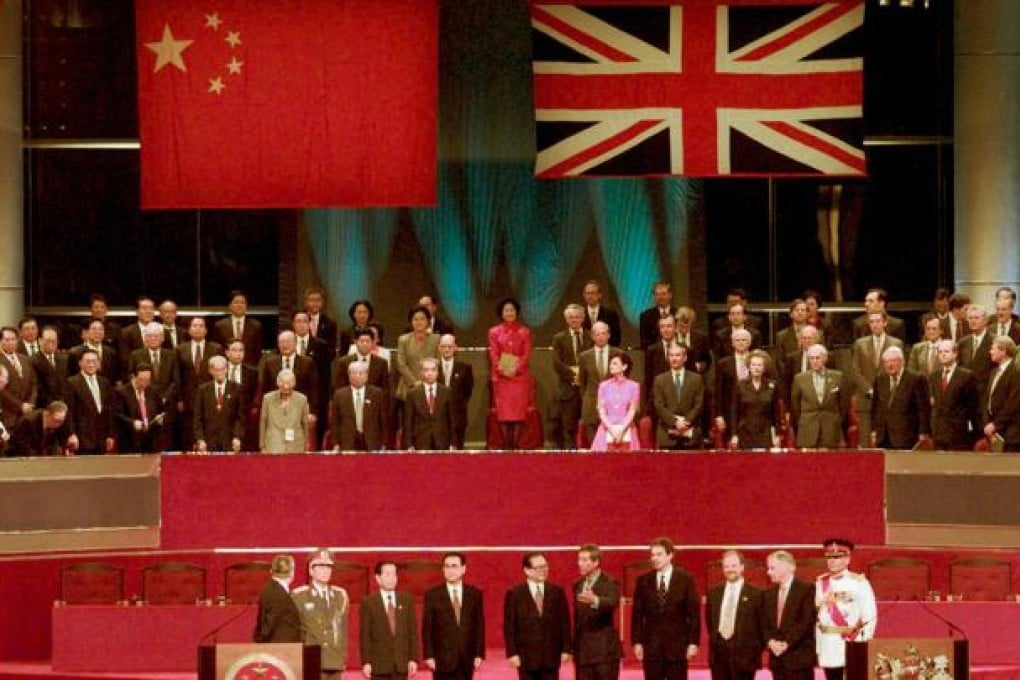 Leaders of China (left) and Britain stand to attention following the hoisting of the Chinese flags at the handover ceremony in 1997. Photo: Reuters