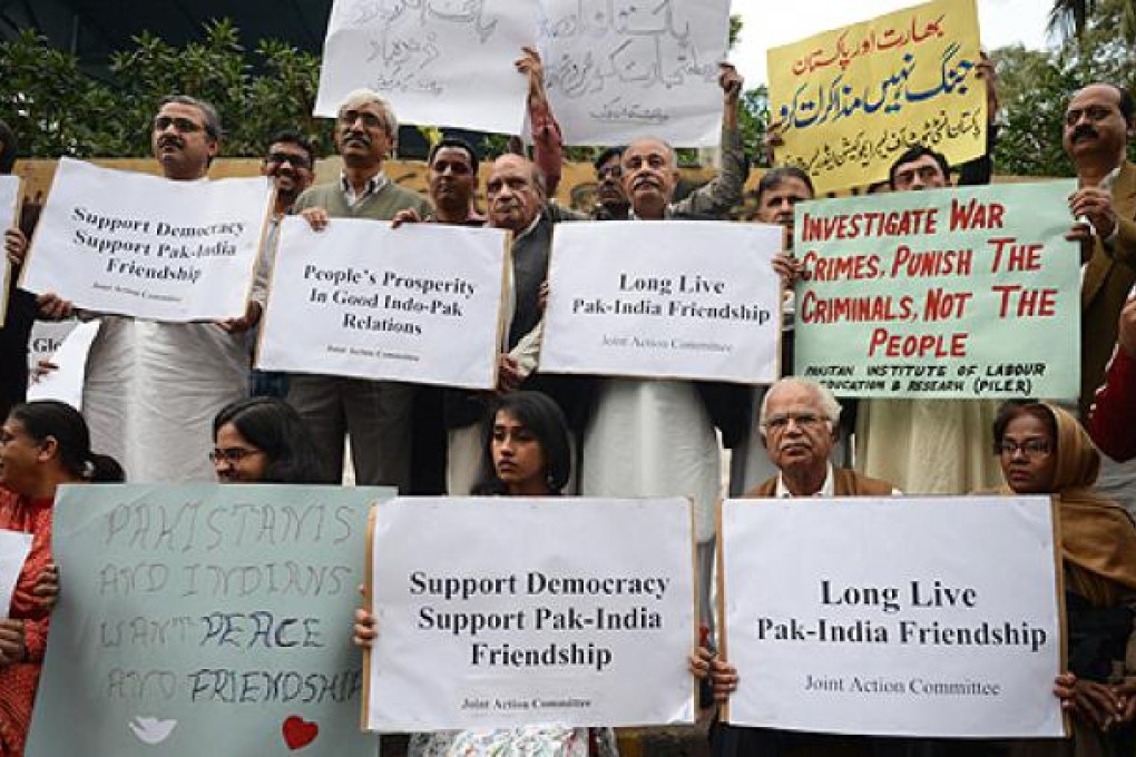 Joint Action Committee for Peoples Rights activists holds placards during a vigil for peace between Pakistan and India in Karachi on Sunday. Photo: AFP