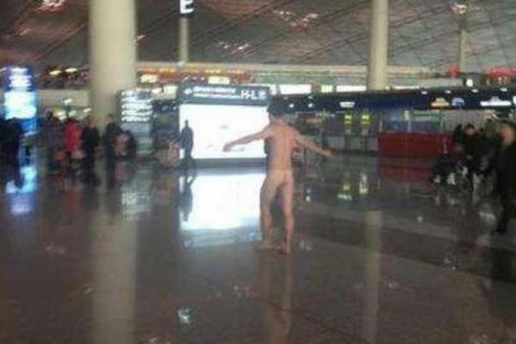 A man streaking at a Beijing airport on Tuesday.