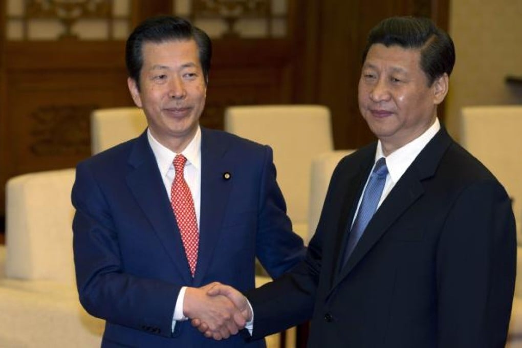Natsuo Yamaguchi (left), leader of the Komeito party from Japan, shakes hands with China's president-in-waiting Xi Jinping during a meeting at the Great Hall of the People in Beijing on January 25, 2013. Photo: AFP