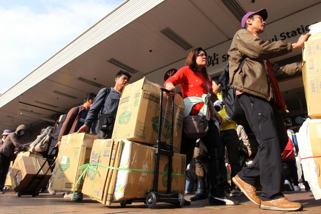 Parallel traders prepare to transport their goods at Sheung Shui train station. Photo: Edward Wong