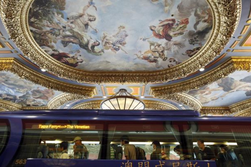 Visitors arrive at the Venetian Macao hotel and casino in Macau. Casino operator Las Vegas Sands says weak results in Las Vegas have dampened a strong performance in Macau and Singapore.