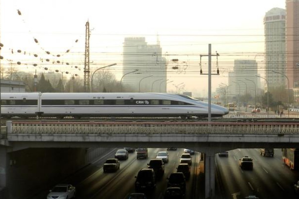 A bullet train crosses a bridge out of Beijing on its 2,298 kilometre journey to Guangzhou. Photo: Xinhua