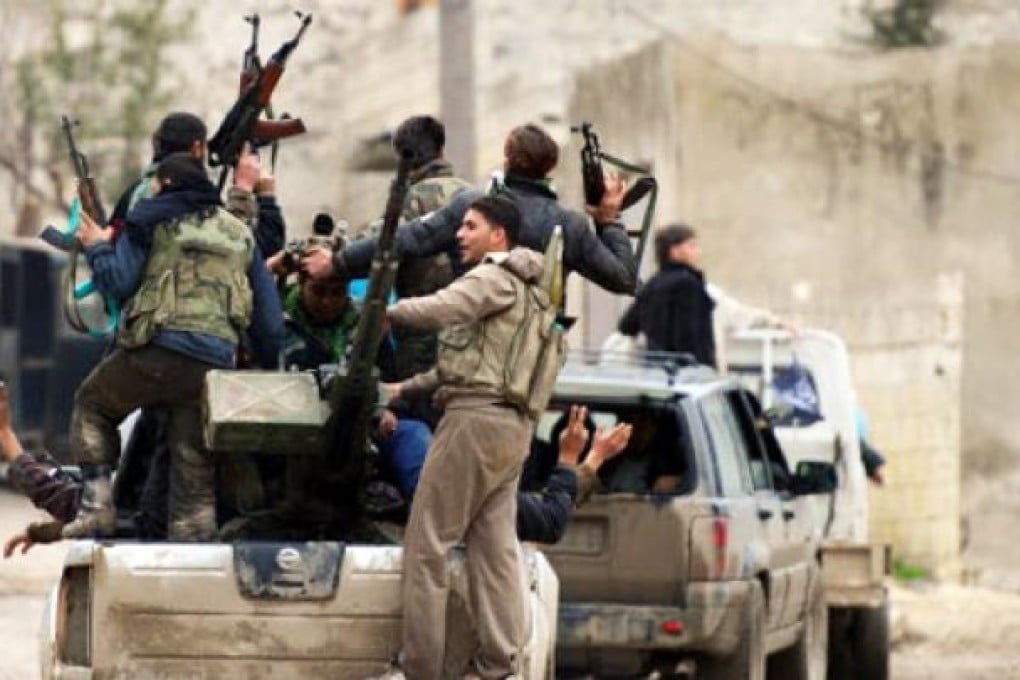 Syrian rebel fighters in action at the village of Aljanodiy. Photo: AFP