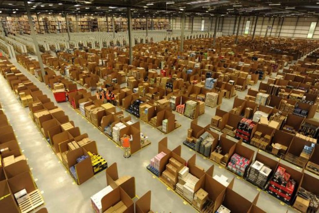 Work is carried out at Amazon's new fulfilment centre after it was opened by Scotland's First Minister Alex Salmond in Dunfermline, Scotland, November 15, 2011.The warehouse covers more than one million square feet (93,000 square metres), about the size of 14 soccer pitches, and is Amazon’s biggest in the United Kingdom. It will create 750 permanent jobs, along with a further 1,500 temporary jobs during peak periods. Photo: Reuters