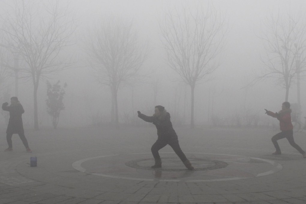 People exercise despite a haze on the mainland. Photo: Reuters