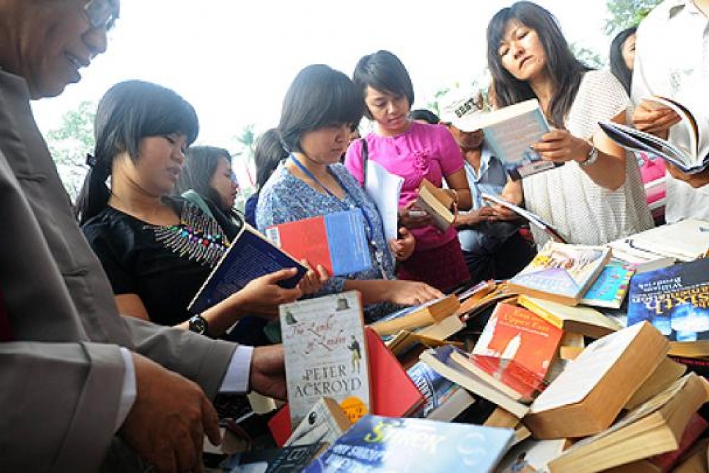 Visitors browse books on sale at a stand outside a hotel hosting Myanmar's first international literary festival, in Yangon on Friday. Photo: AFP