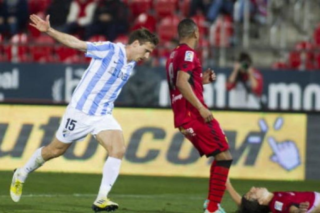 Malaga's defender Nacho Monreal celebrates after scoring against Mallorca during the Spanish league football match Mallorca vs Malaga. Photo: AFP