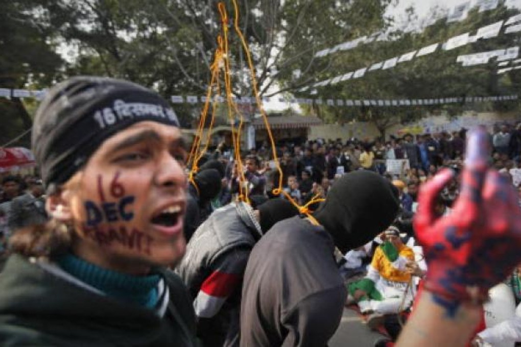 An Indian shouts slogans as others enact a mock hanging during a recent protest demanding the death penalty for six men accused of a fatal gang rape in New Delhi