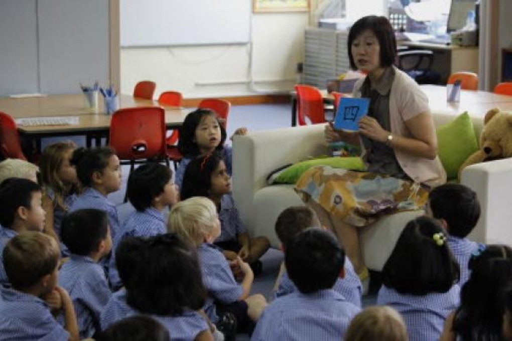 A teacher shows the Chinese character "Four" to students at an international school in Hong Kong. Photo: Reuters