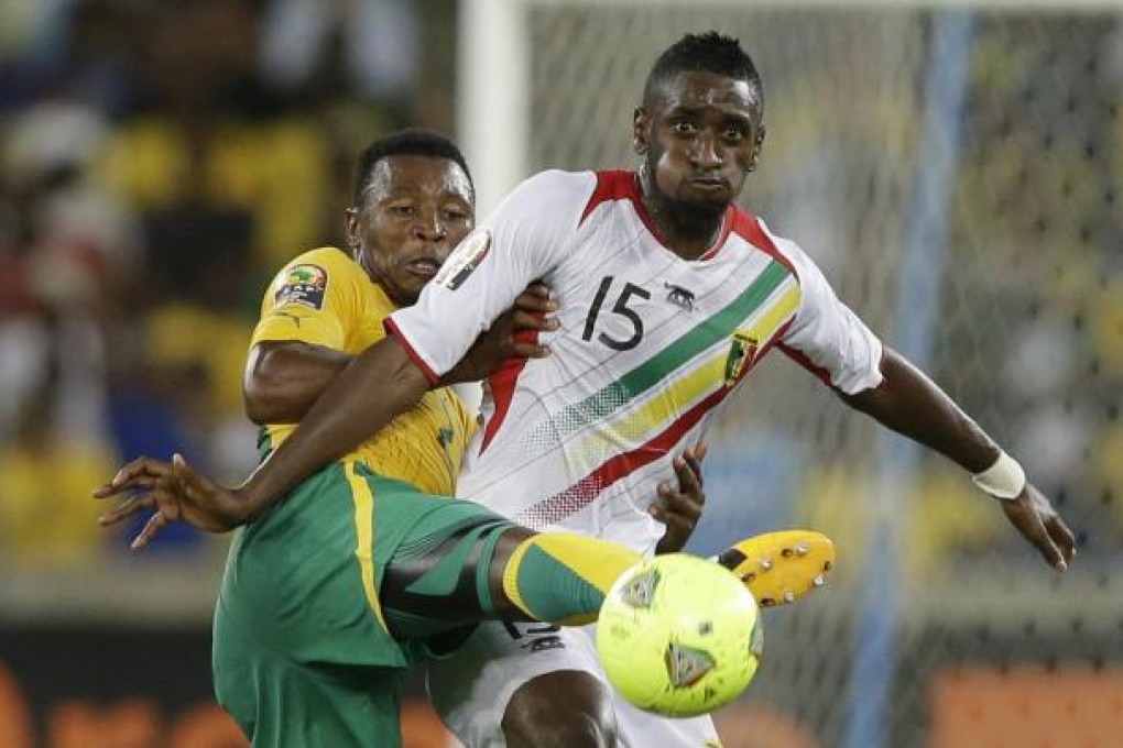 Mali's Mahamadou Samassa battles for the ball. Photo: AP